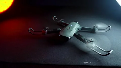 Quadcopter in a dark room illuminated by red light Vídeo Stock 302960265