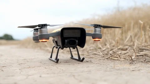Quadcopter drone close-up flying above the ground. Stock Footage 114638451