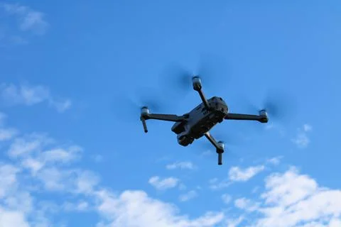 Quadcopter drone flying from below Stock Photos
