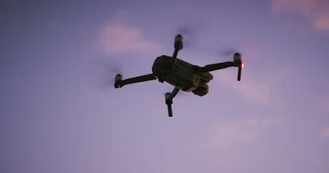 Quadcopter drone flying at dusk Stock Footage 120216530