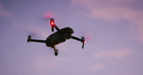 Quadcopter drone flying at dusk Stock Footage 120216903