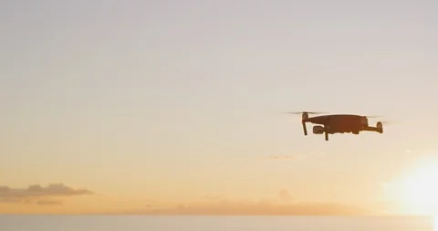 Quadcopter drone flying at sunset Stock Footage 120199710