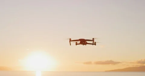 Quadcopter drone flying at sunset Stock Footage 120200397