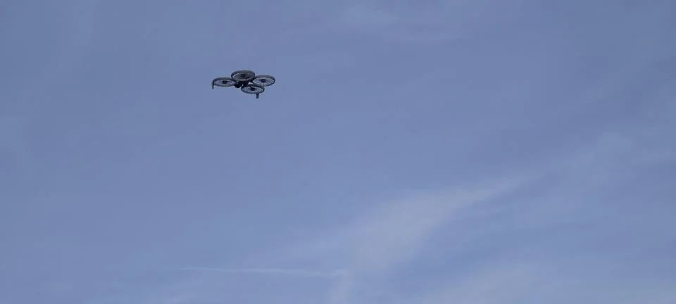Quadcopter drone hovering mid‑air Stock Photos