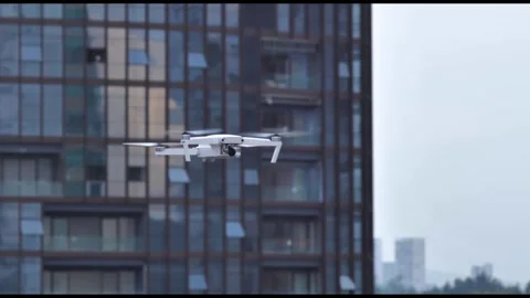 Quadcopter Drone Hovering Near Modern Glass Skyscraper Building Stock-Footage 342960753
