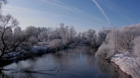 The quadcopter flies along the riverbed towards the bridge with the highway Stock Footage 167720619