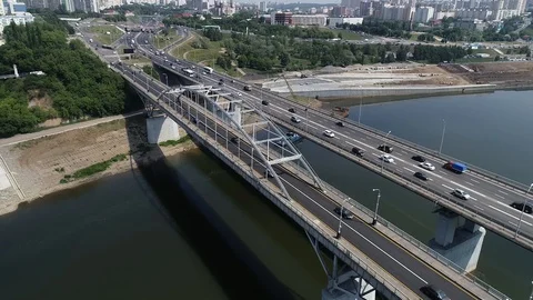 Quadcopter flies over a bridge with dense traffic and flies to the city. Stock Footage 127893375
