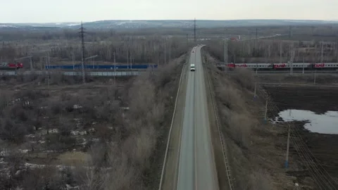 The quadcopter flies over the bridge over the railway Stock Footage 151252671