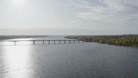 A quadcopter flies over a bridge over a river in Old Russia, cars drive across Video stock 306146311