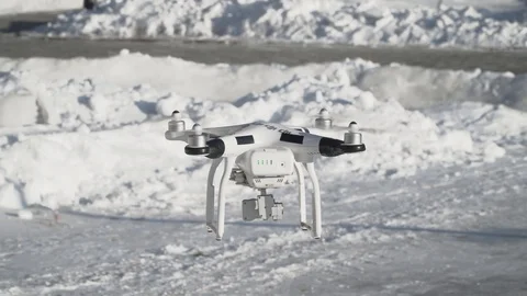Quadcopter Flying against the background of snow in winter Stock Footage 87471937