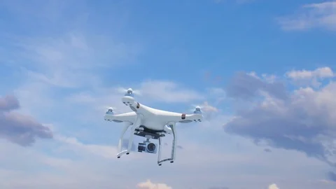 Quadcopter Flying in the Blue Sky with its Camera and Rising Fast Up to the Sun Stock Footage 81772739