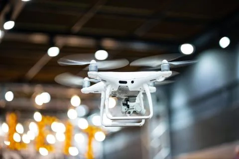 Quadcopter flying inside a large warehouse Stock Photos