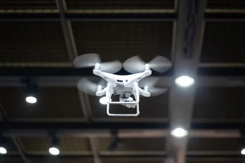Quadcopter flying inside a large warehouse Stock Photos
