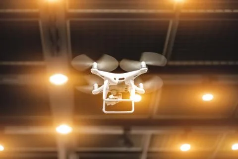 Quadcopter flying inside a large warehouse Stock Photos