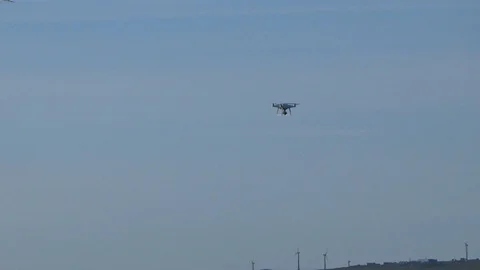 Quadcopter flying next to the seagulls Stock Footage 100248789
