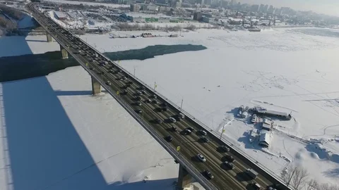 Quadcopter flying over a bridge across the Ob river. Video stock 77129286