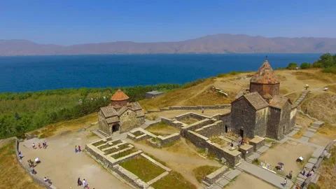 Quadcopter flying over old Sevanavank monastery complex, tourism in Armenia Stock Footage 85775279