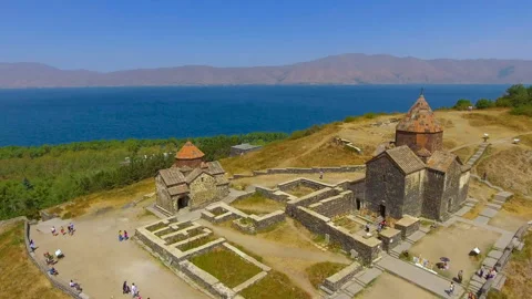 Quadcopter flying over old Sevanavank monastery complex, tourism in Armenia Stock Footage 85844935