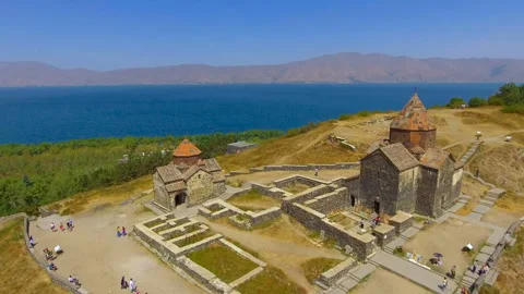Quadcopter flying over old Sevanavank monastery complex, tourism in Armenia Stock Footage 85867557