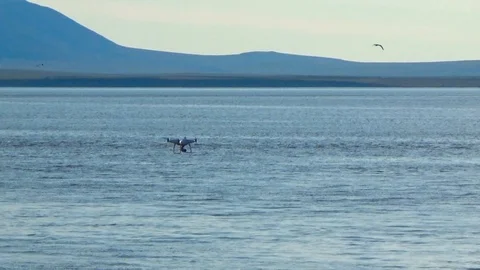 Quadcopter flying over the sea Stock Footage 100248479