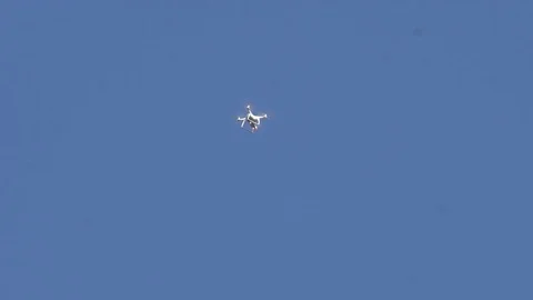 Quadcopter flying in the sky in the far distance Stock Footage 79185817