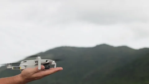 A quadcopter lands on a persons palm. Stock Footage 321727905