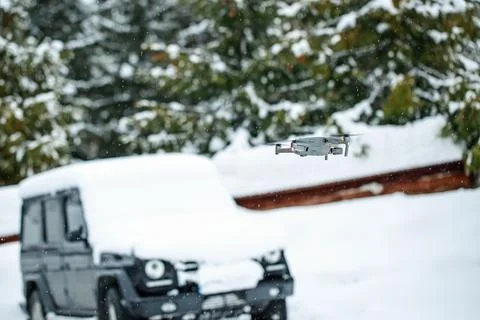 Quadcopter launch in winter snowy forest. Stock Photos