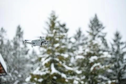 Quadcopter launch in winter snowy forest. Stock Photos