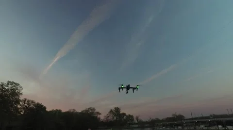 A quadcopter or drone flying in the evening light, 4K UHD Stock Footage 61649376