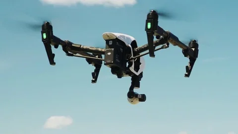 Quadcopter or Drone Soars Up Into the Blue Sky Stock Footage 75996015