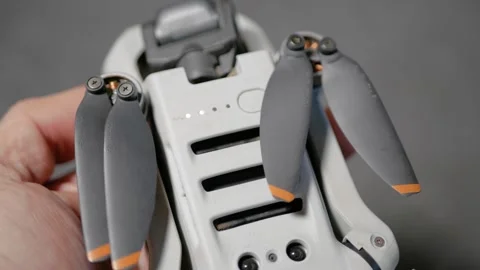 The quadcopter pilot turns on the drone using the power button. Stock Footage 292009486
