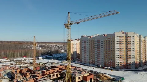 The quadcopter rises up along the construction crane. Construction site in Stock Footage 151502010