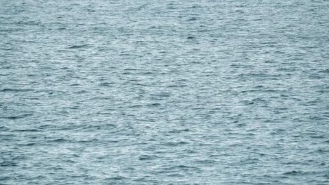 Quadcopter in slow motion hovering over water Stock Footage 126005613