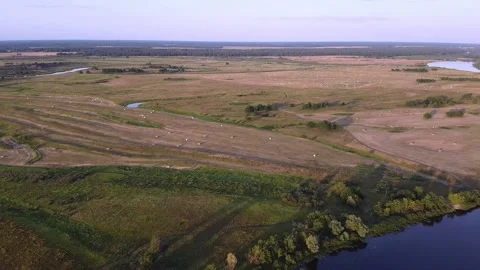 The quadcopter slowly descends towards the river Stock Footage 139768139