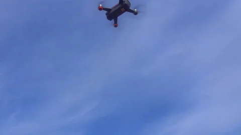 Quadcopter soars into the blue sky, shooting from below Video stock 89185460