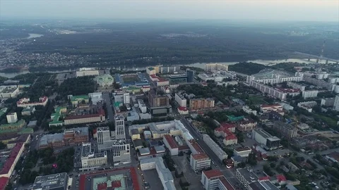 Quadcopter at sunset flying over the city and relieves the landscape. 動画素材 127893641
