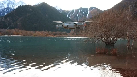 The quadcopter takes off from the beach of lake 動画素材 229797057