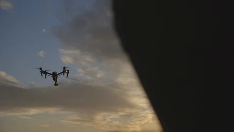 Quadcopter drone in flight at dusk Stock Footage 89972053