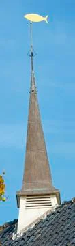 Quadrangular belfry with fish weather vane Stock Photos