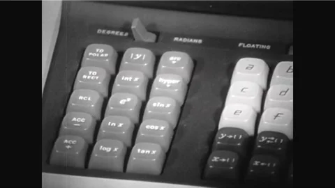 A quadratic equation is shown and a computing calculator is programmed and a Stock Footage 92631844