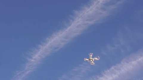 Quadrocopter with a camera in the blue sky. Stock Footage 81318532