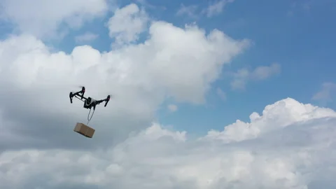 Quadrocopter Carrying a Parcel in the Air Stock Footage 133185121