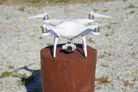 Quadrocopter DJI Phantom 4 on a wooden hemp. Preparing the drone for the flig Stock Photos