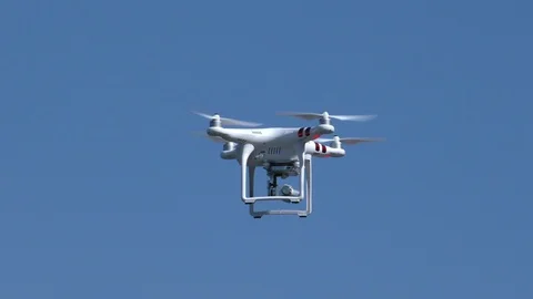 Quadrocopter flies in the blue sky. Stock Footage