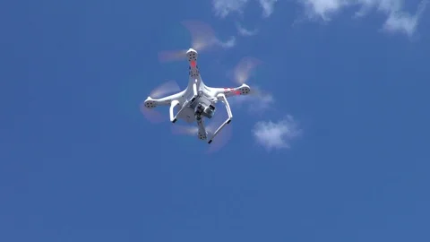 Quadrocopter flies in the blue sky. Stock Footage 114918482