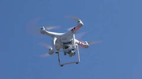 Quadrocopter flies in the blue sky. Stock Footage 114918500
