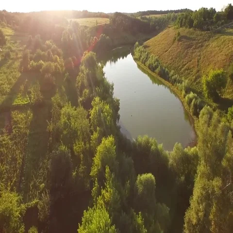 Quadrocopter Flying Over the Meadows and Canals, Over Fields and Dirt Roads Stock Footage 69504282