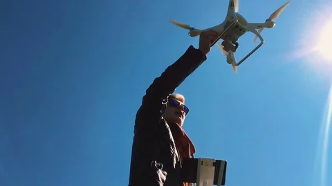 Quadrocopter lands on the pilot's hand. The pilot catches the drone. Slow motion Stock Footage 74410475