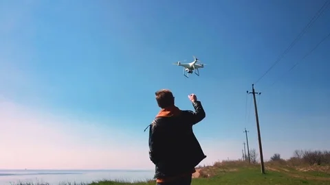 Quadrocopter lands on the pilot's hand. The pilot catches the drone. Slow motion Stock Footage 74410591