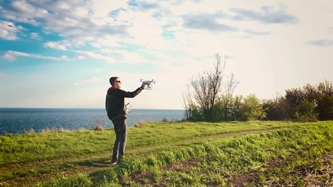 Quadrocopter lands on the pilot's hand. The pilot catches the drone. Slow motion Stock Footage 74794631